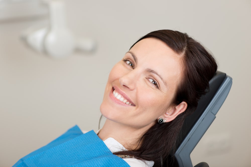 mid adult female patient smiling in dentistry